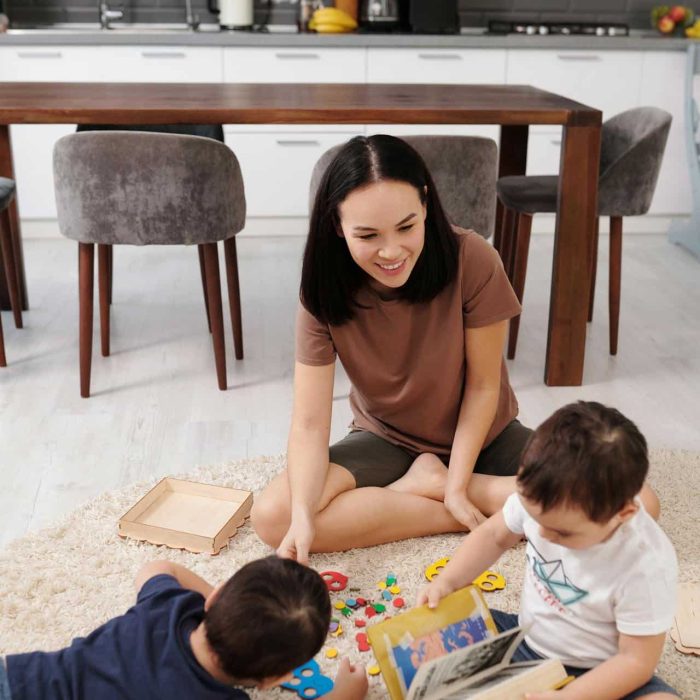 Parent and child playing with a variety of STEM toys on a living-room floor, turning chaos into curiosity.